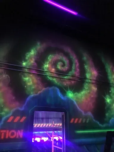 Two-story laser tag arena at SacTag Sacramento — 8,500 sq ft of neon-lit multi-level tactical terrain