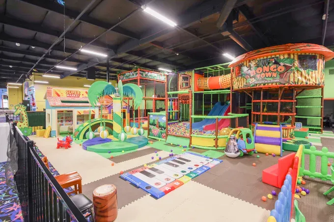 Indoor playground for toddlers in Sacramento — jungle-themed play area at SacTag with slides, tunnels, climbing