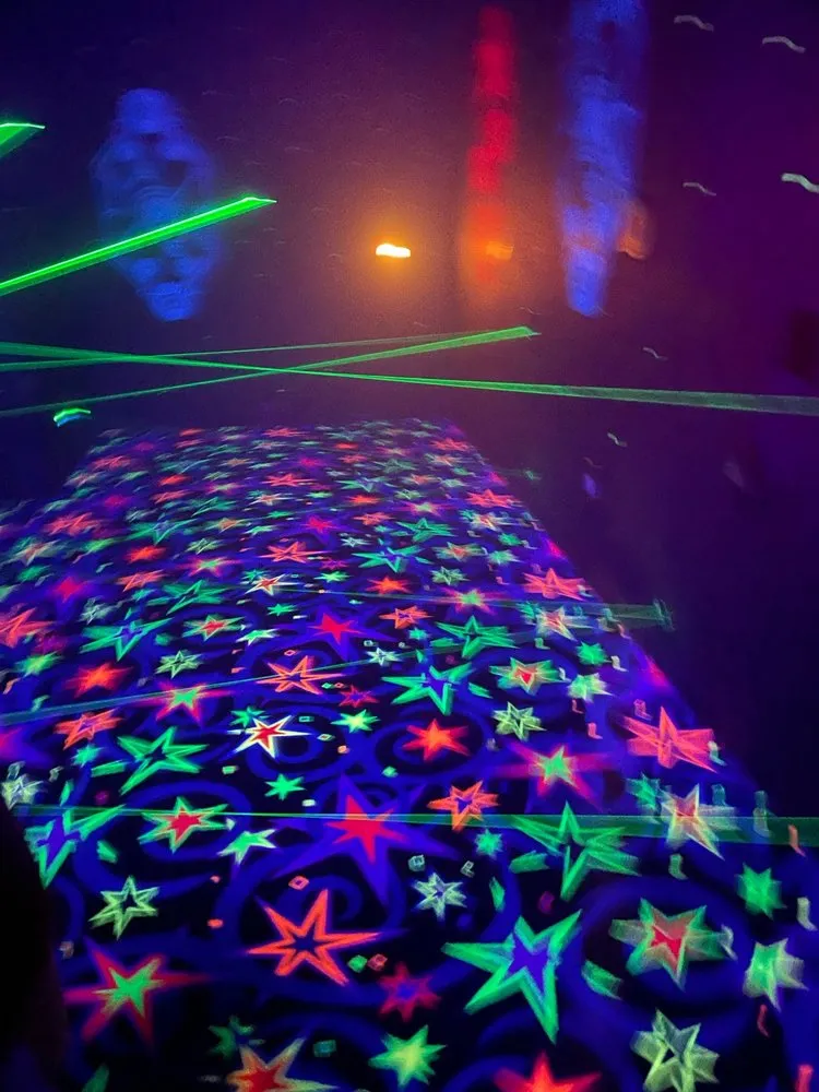Dark futuristic corridor with red and blue lights inside the multi-level laser tag arena.